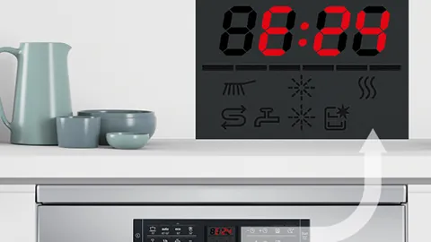 A Bosch oven with a digital clock showing 8:24, next to a set of light blue bowls and a jug.