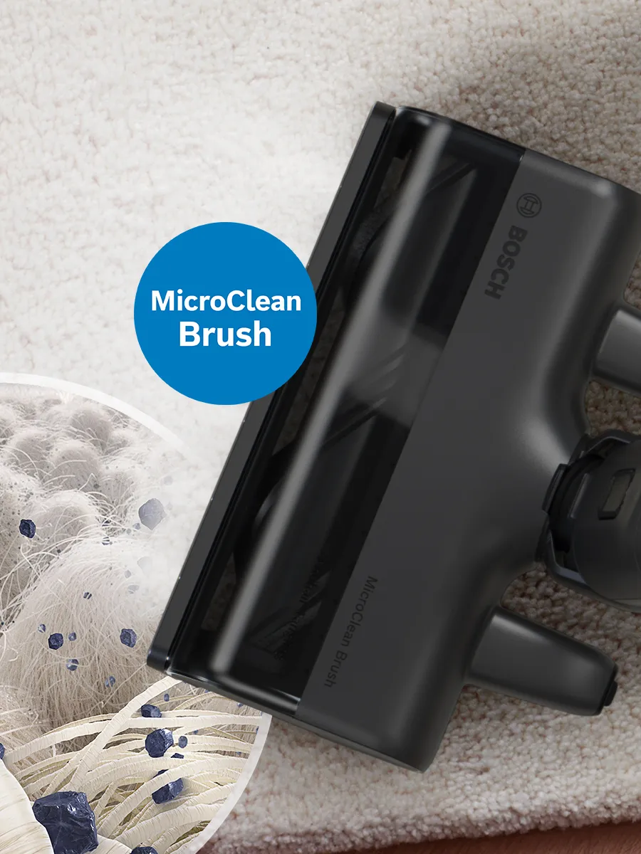 The MicroClean Brush on a carpet and and magnifying glass section with micro view of carpet fibres and smallest dust particles.