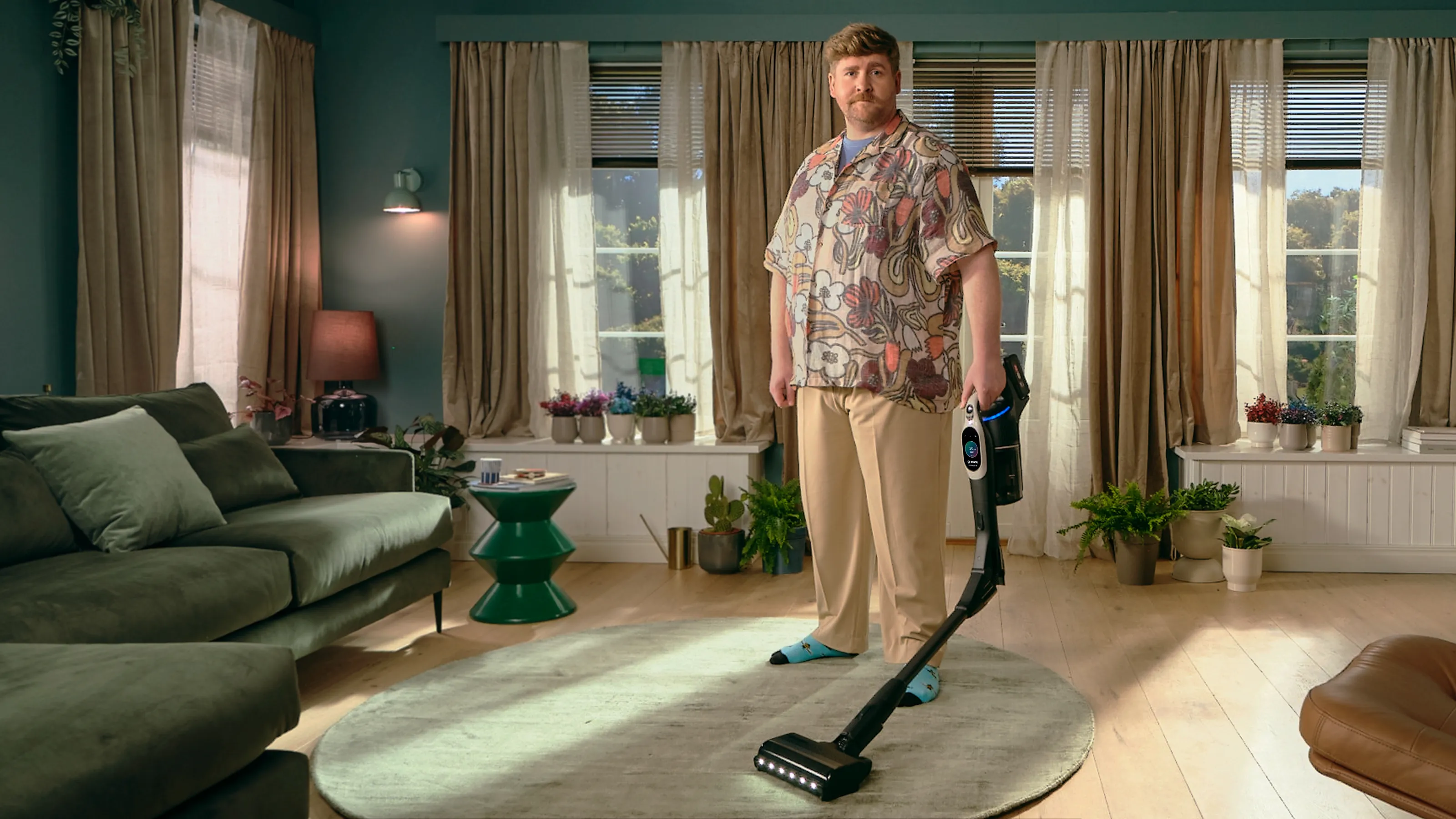 Man standing in a living room holding the Unlimited 10 with bent tube.