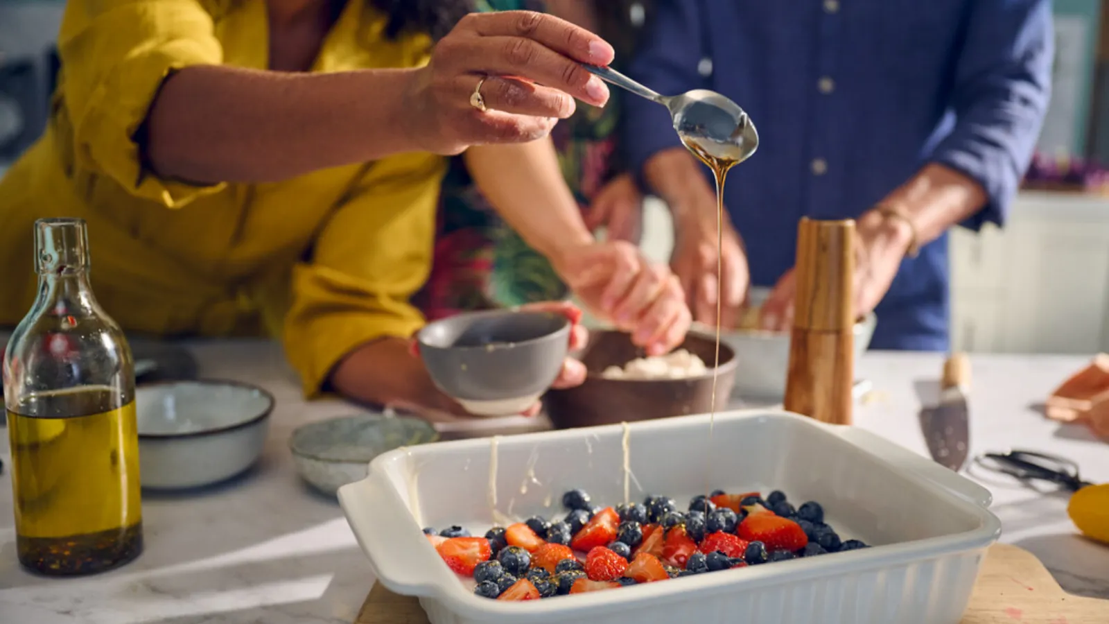 A diverse group of individuals working together in a kitchen, preparing delicious food with focus and coordination.