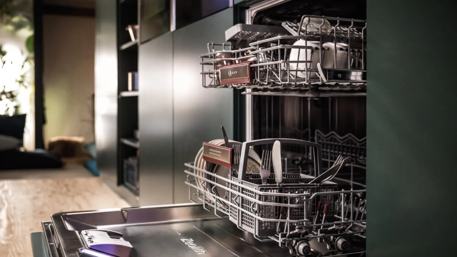 A dishwasher filled with various dishes, ready to be cleaned.