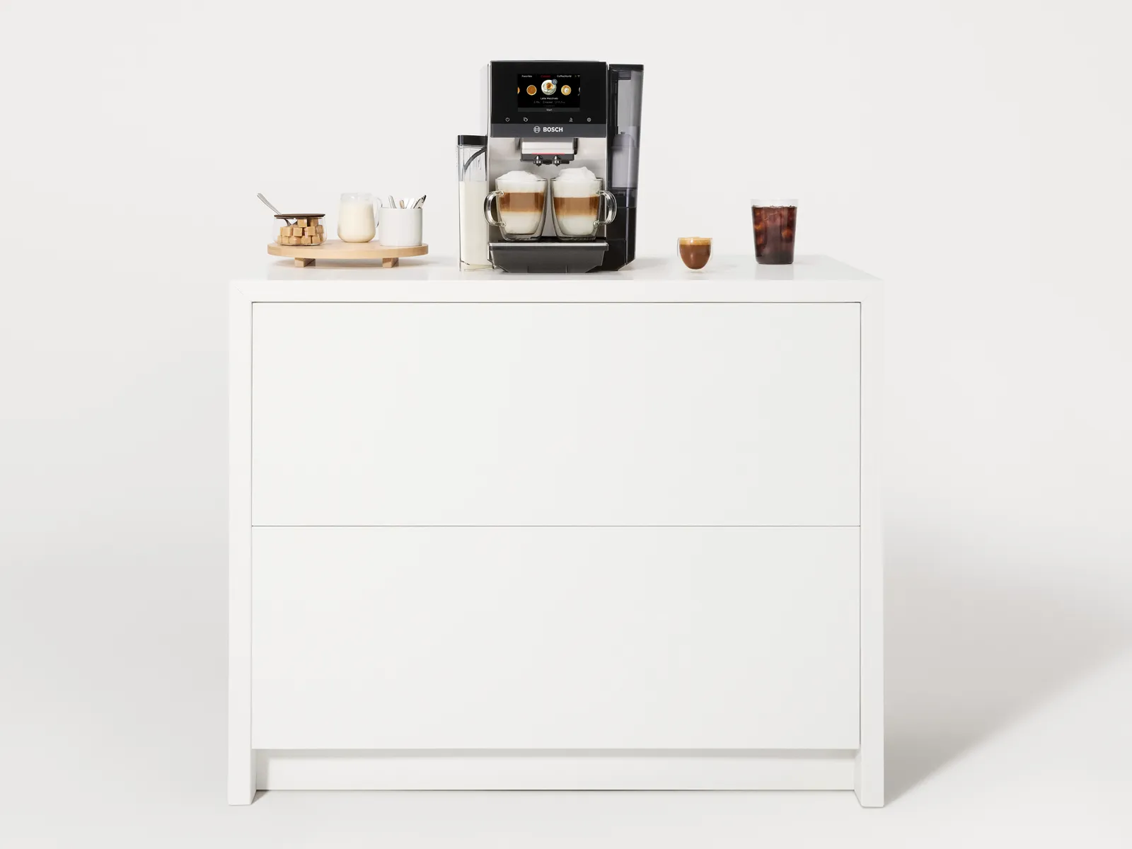 Bosch 800 Series fully automatic espresso machine with coffee drinks on white countertop