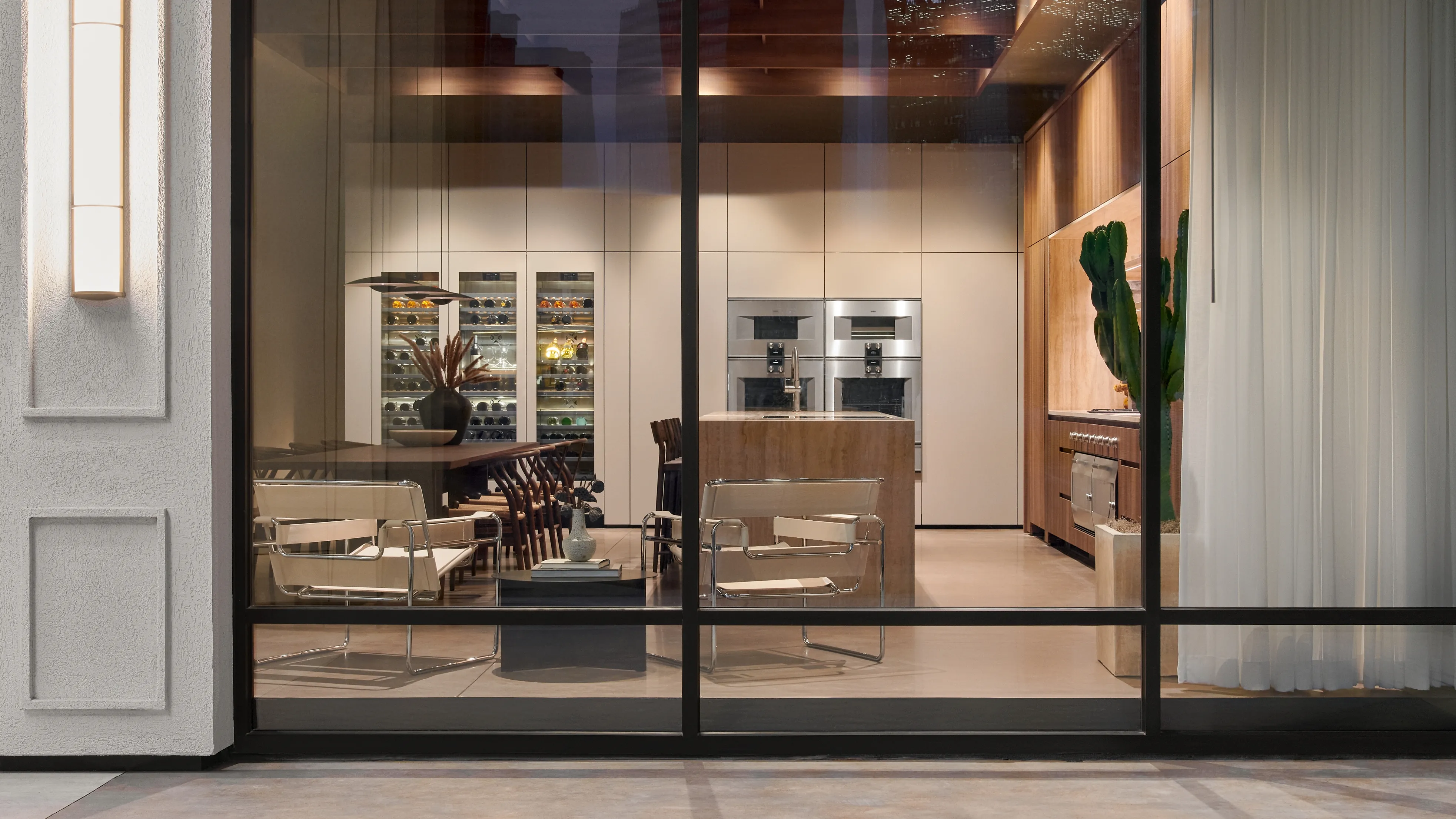 Looking into the brightly lit Gaggenau Houston Flagship showroom window at night