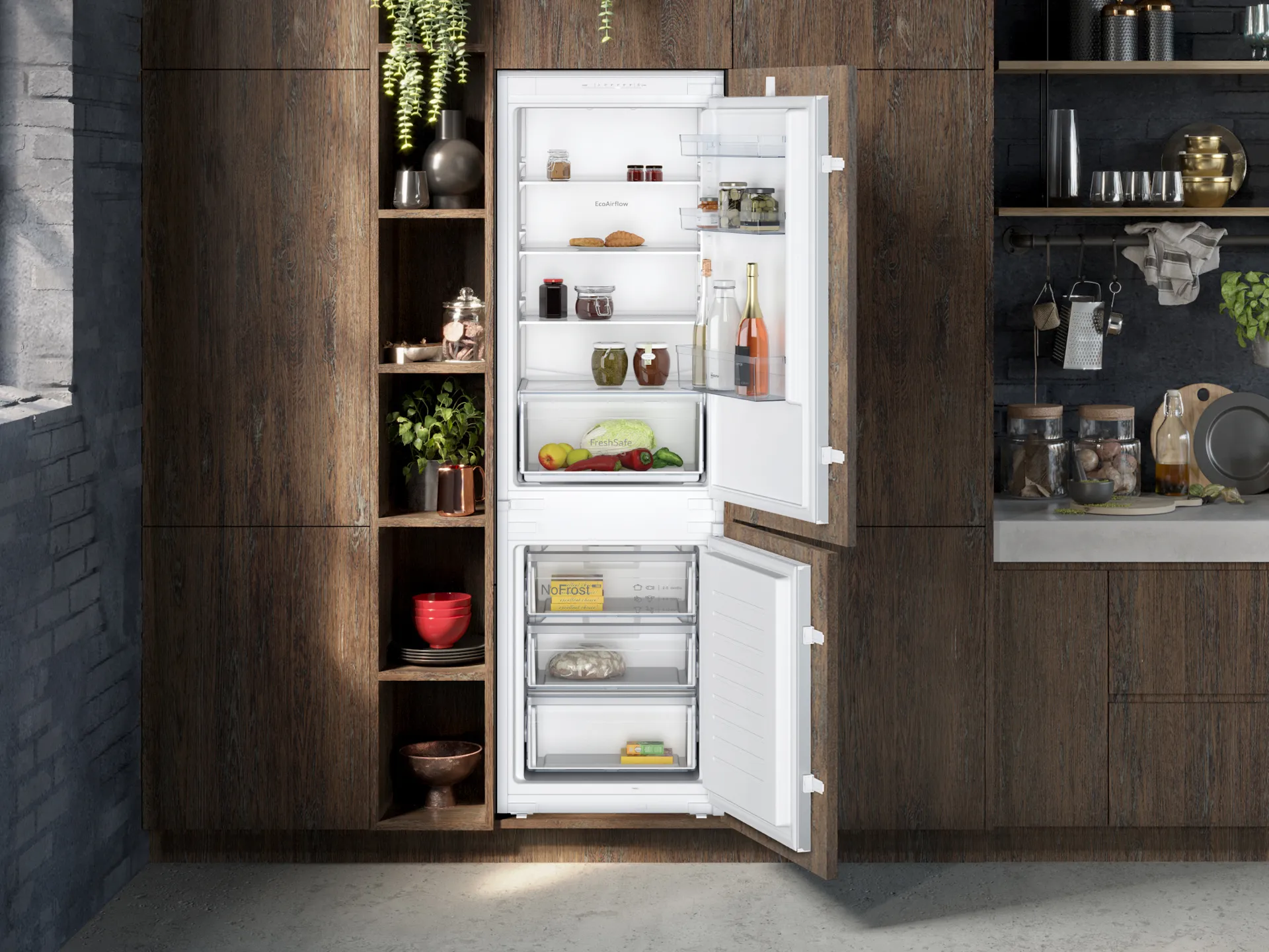 Built in fridge freezer with both doors open showing interior set in a dark toned decorated kitchen