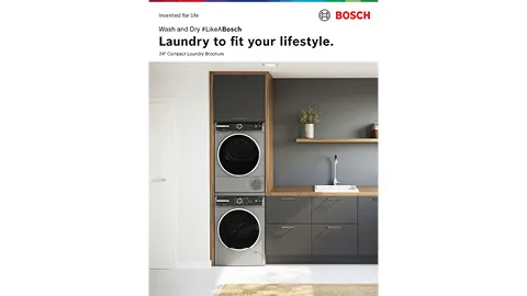 Bosch washer and dryer stacked in a modern laundry room with cabinets and sink.