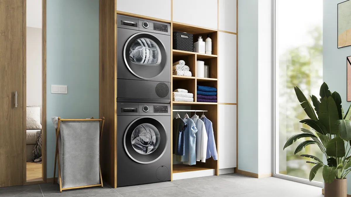 Folded coloured clothes on top of a washer.