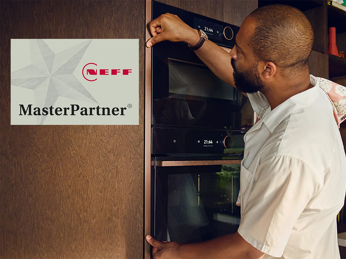 Man adjusting Neff MasterPartner appliance in kitchen, Neff logo visible.