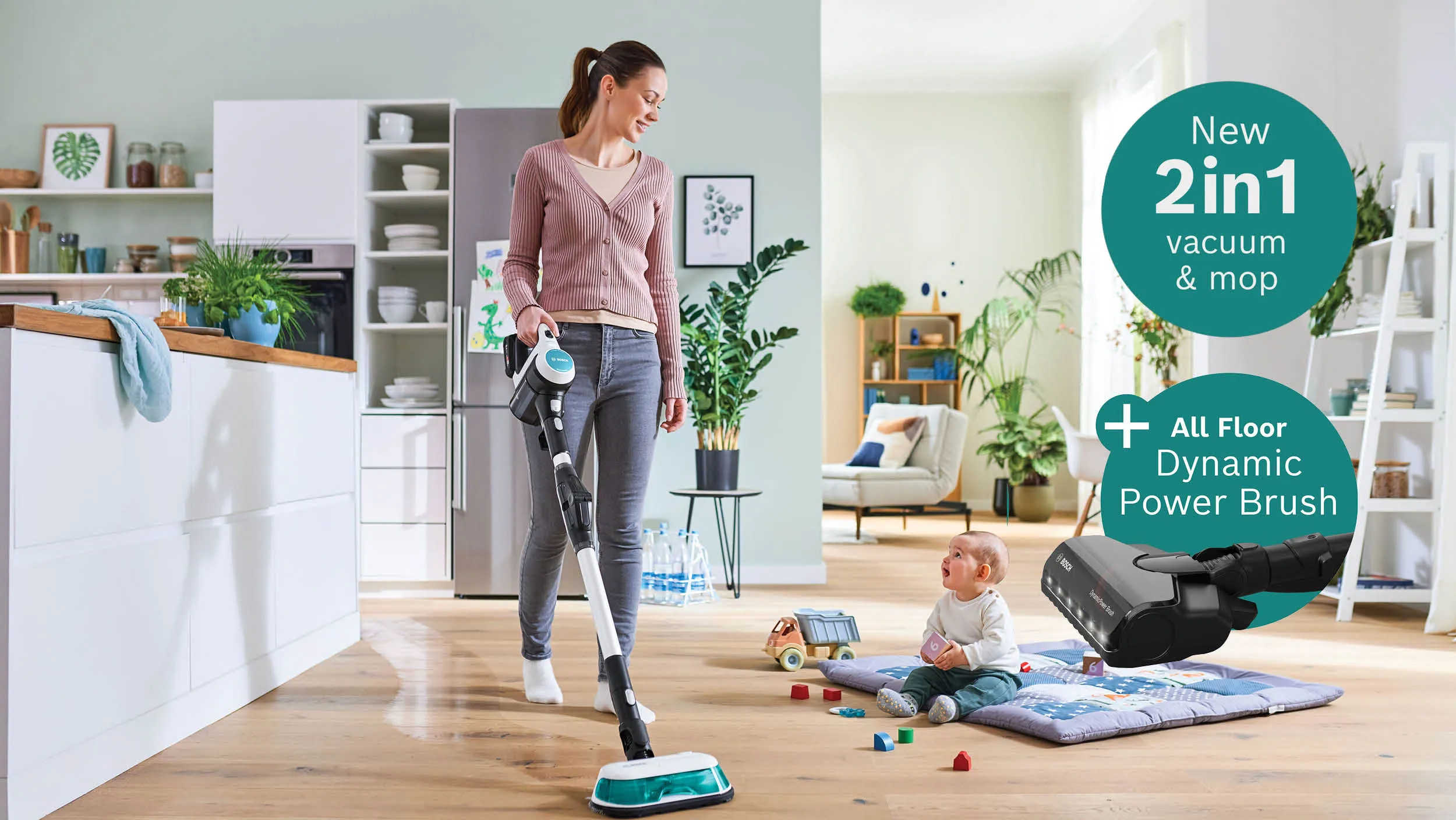 A woman uses a 2-in-1 vacuum and mop in a bright, modern living space while a baby plays on a mat nearby.