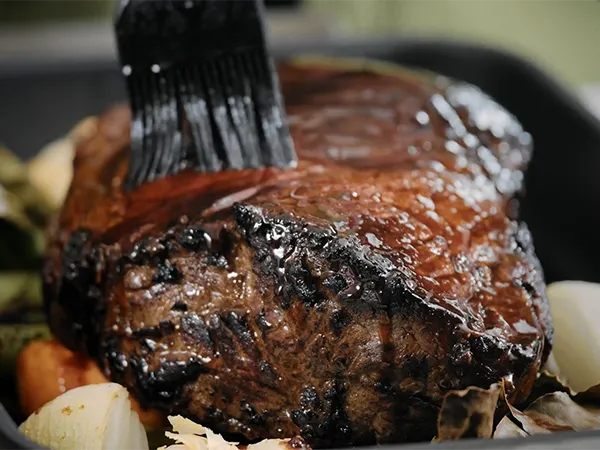 Brush glazing beef roasting joint