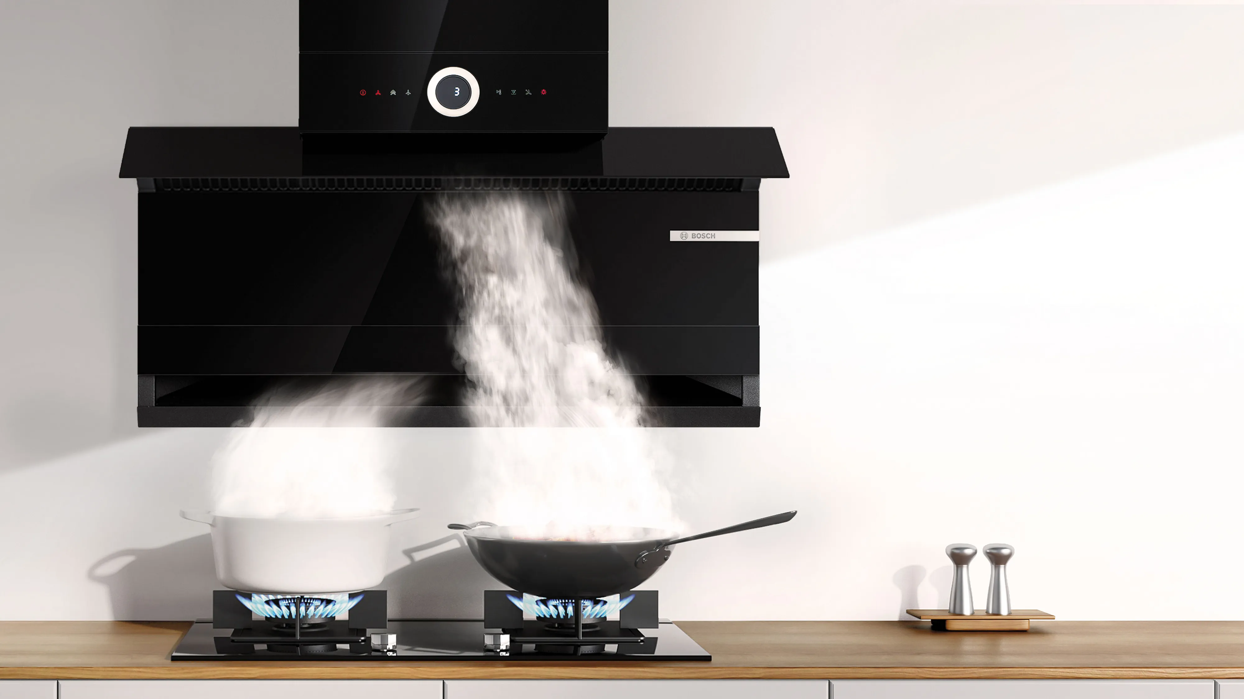A black kitchen hood mounted above a cooktop, with a 90cm measuring scale displayed for reference.