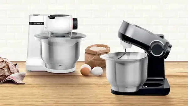 Bosch food processor next to an array of tools and ingredients.