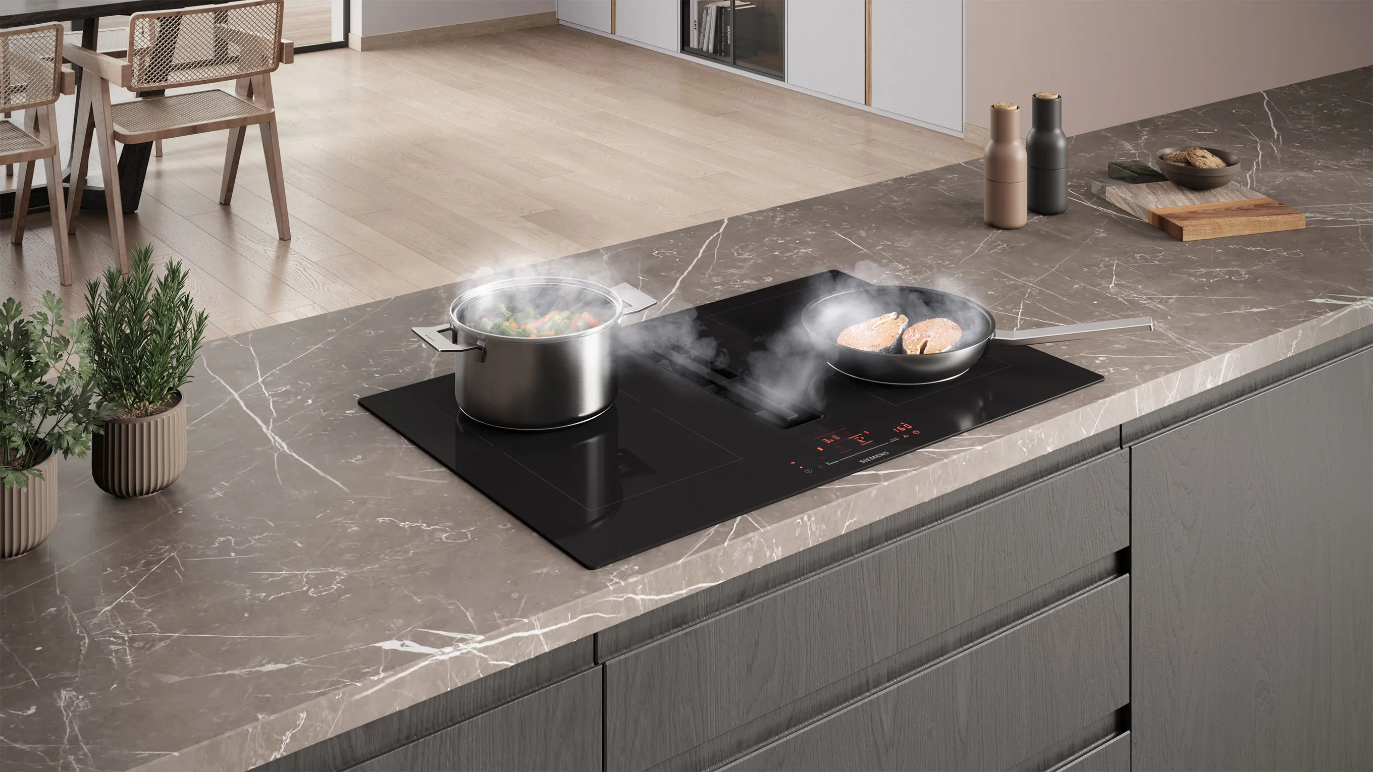 Pans cooking on induction hob with extractor fan