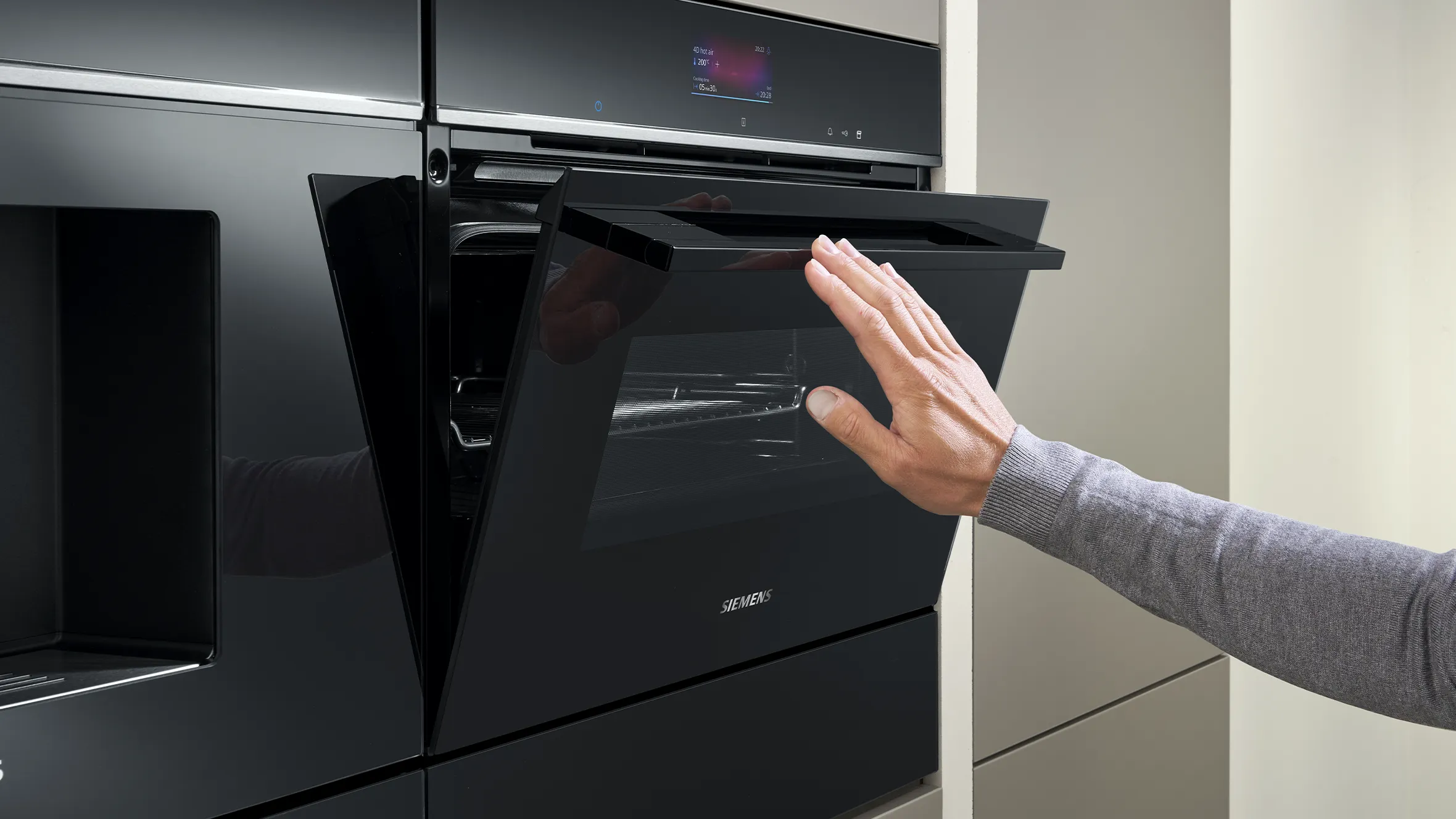 Person pushing door up on oven appliance