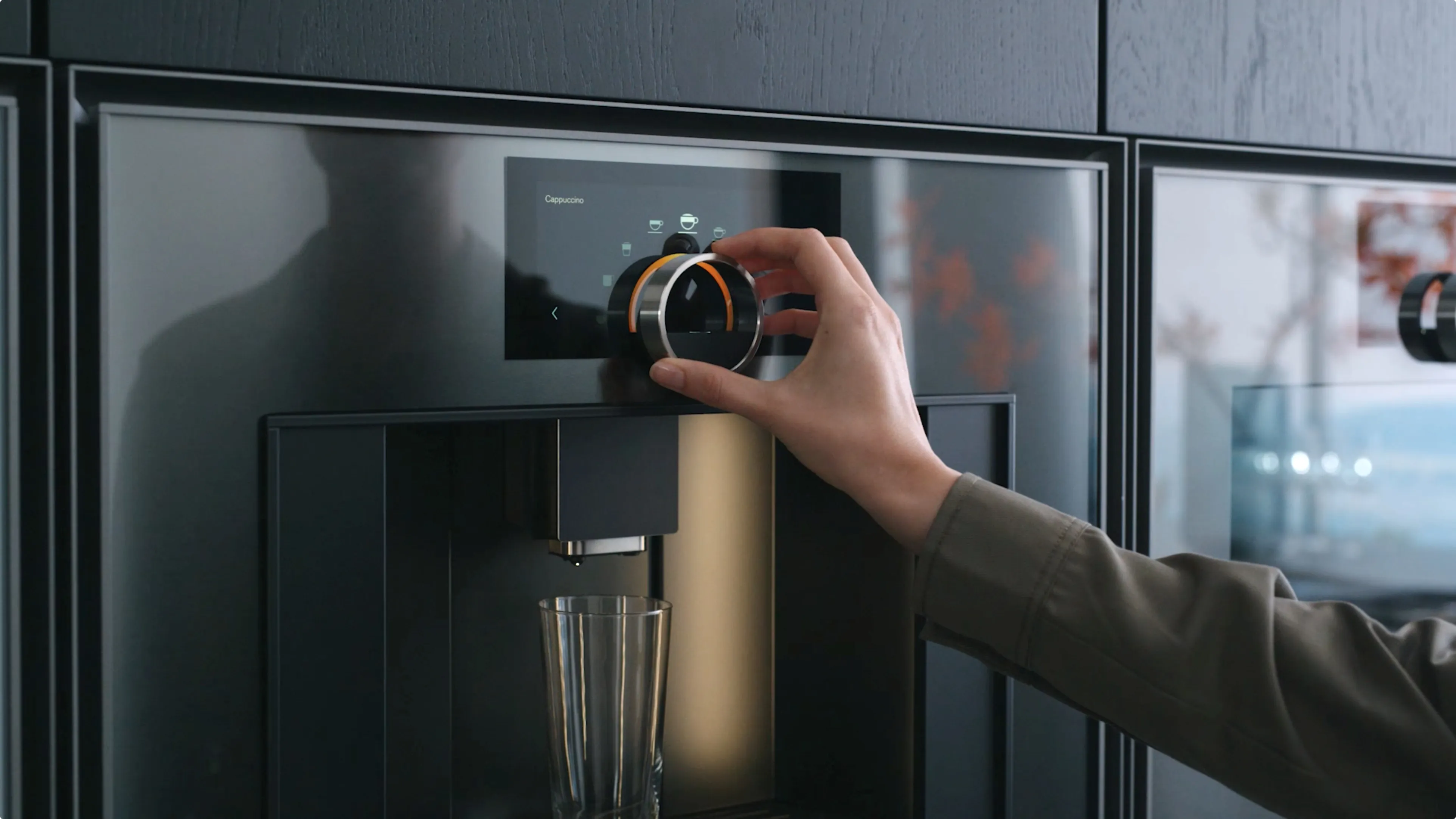 A close-up of a user selecting from various types of coffee beverages on the Gaggenau Expressive series fully automatic espresso machine