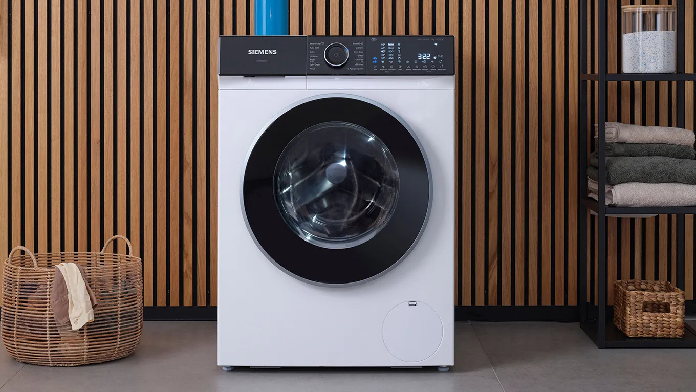 Siemens tvättmaskin längst fram och japandi-stilens trädekorerade vägg i bakgrunden.