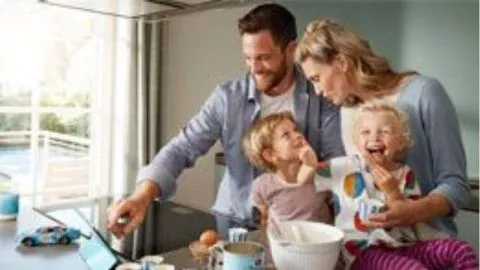 Family enjoying quality time together at home, cooking and laughing.