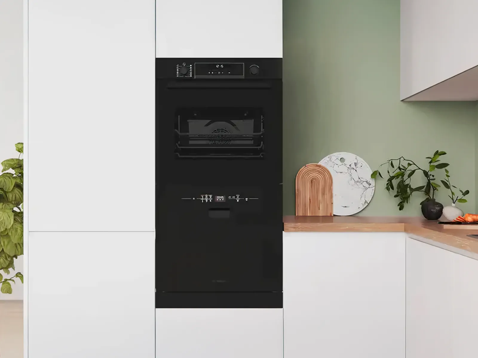 Kompakt diskmaskin under ugnen.