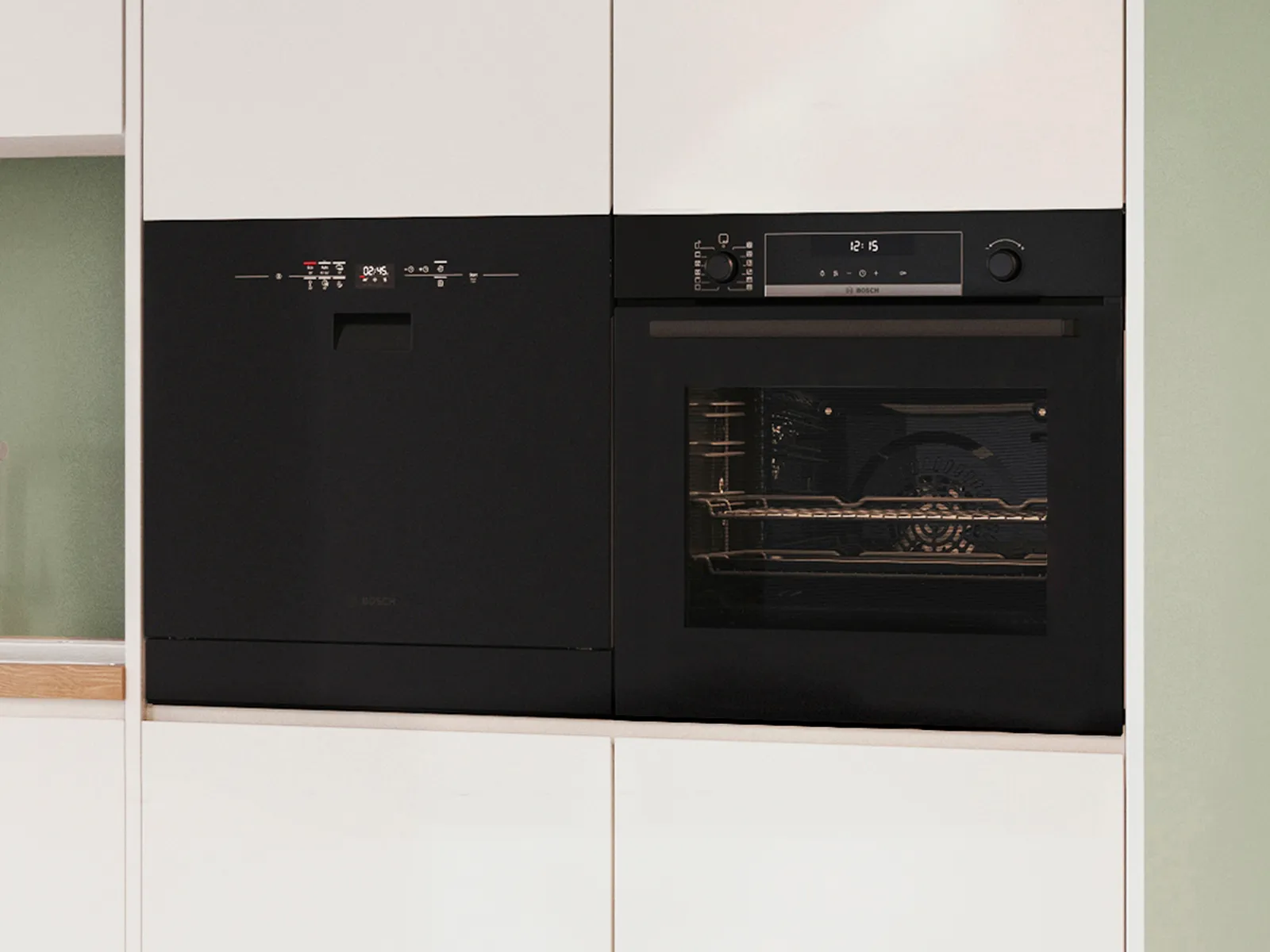 Svart diskmaskin bredvid svart ugn.