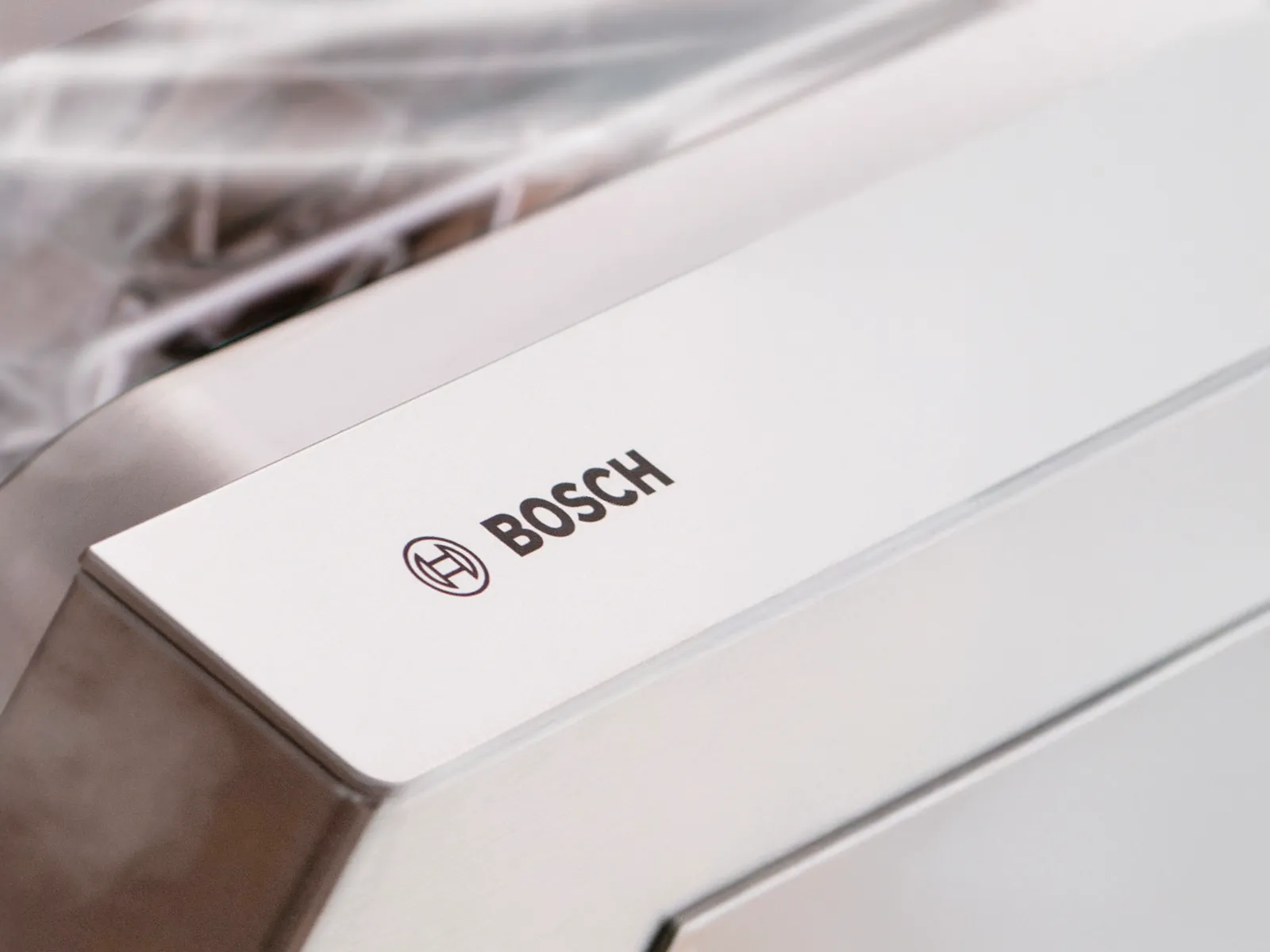 Close-up of Bosch branding on a dishwasher, reflecting the rigorous quality checks for durability and trusted performance.