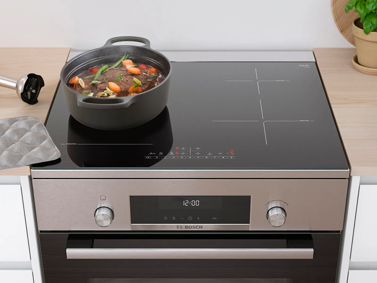 Large pot on a Bosch freestanding cooker with induction hob, designed to fit seamlessly into kitchens of all sizes.