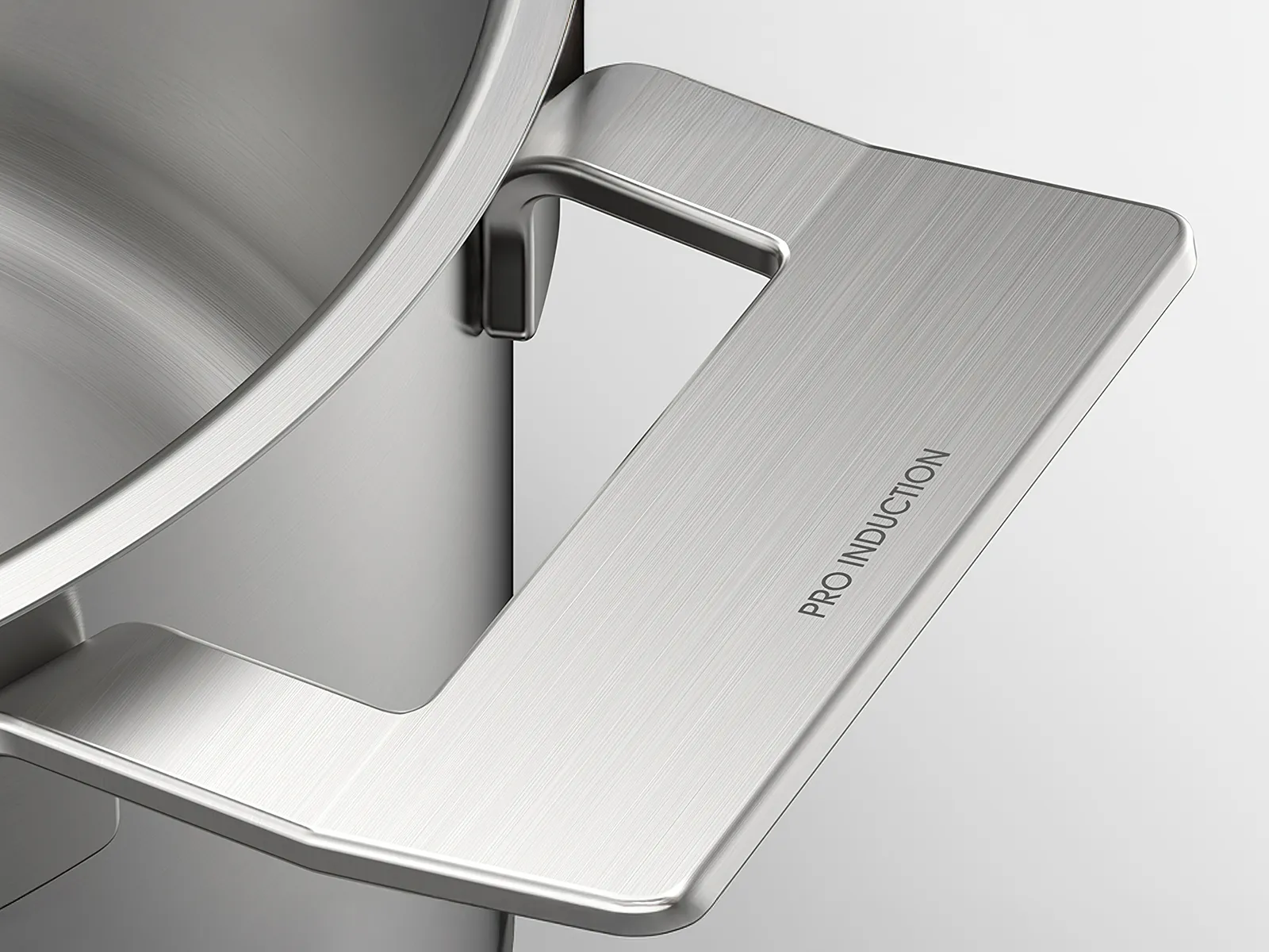 Close-up of a stainless steel pot handle engraved with "PRO INDUCTION" showcasing its sleek design and modern aesthetic. 