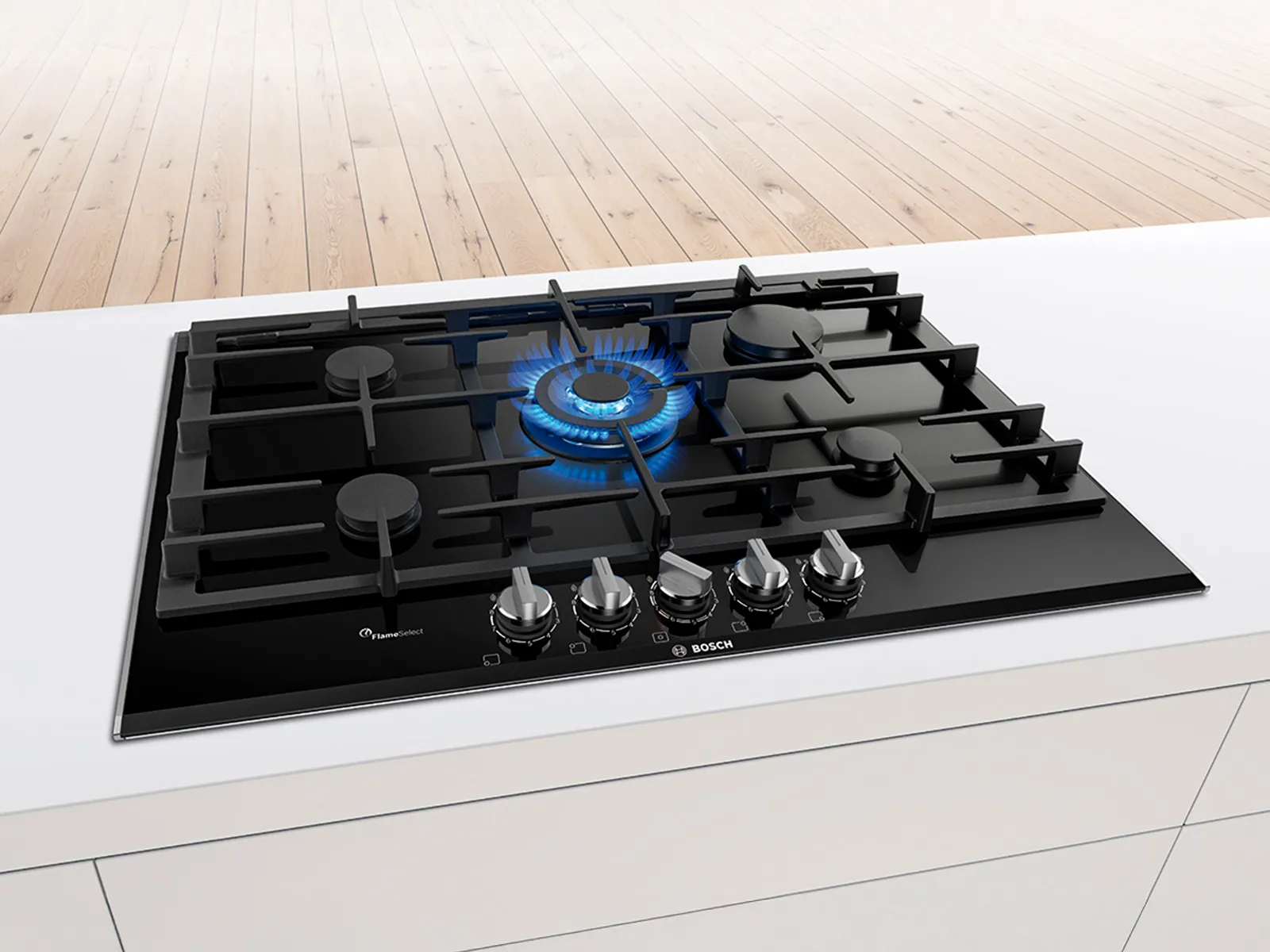 Modern gas stove with one burner lit on a kitchen countertop.
