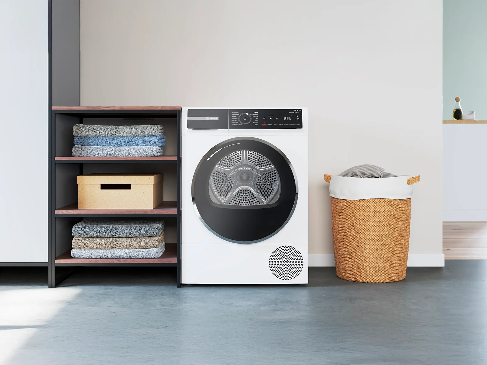 A white Siemens dryer next to a shelving unit with folded towels and a wicker laundry basket in a modern laundry room.
