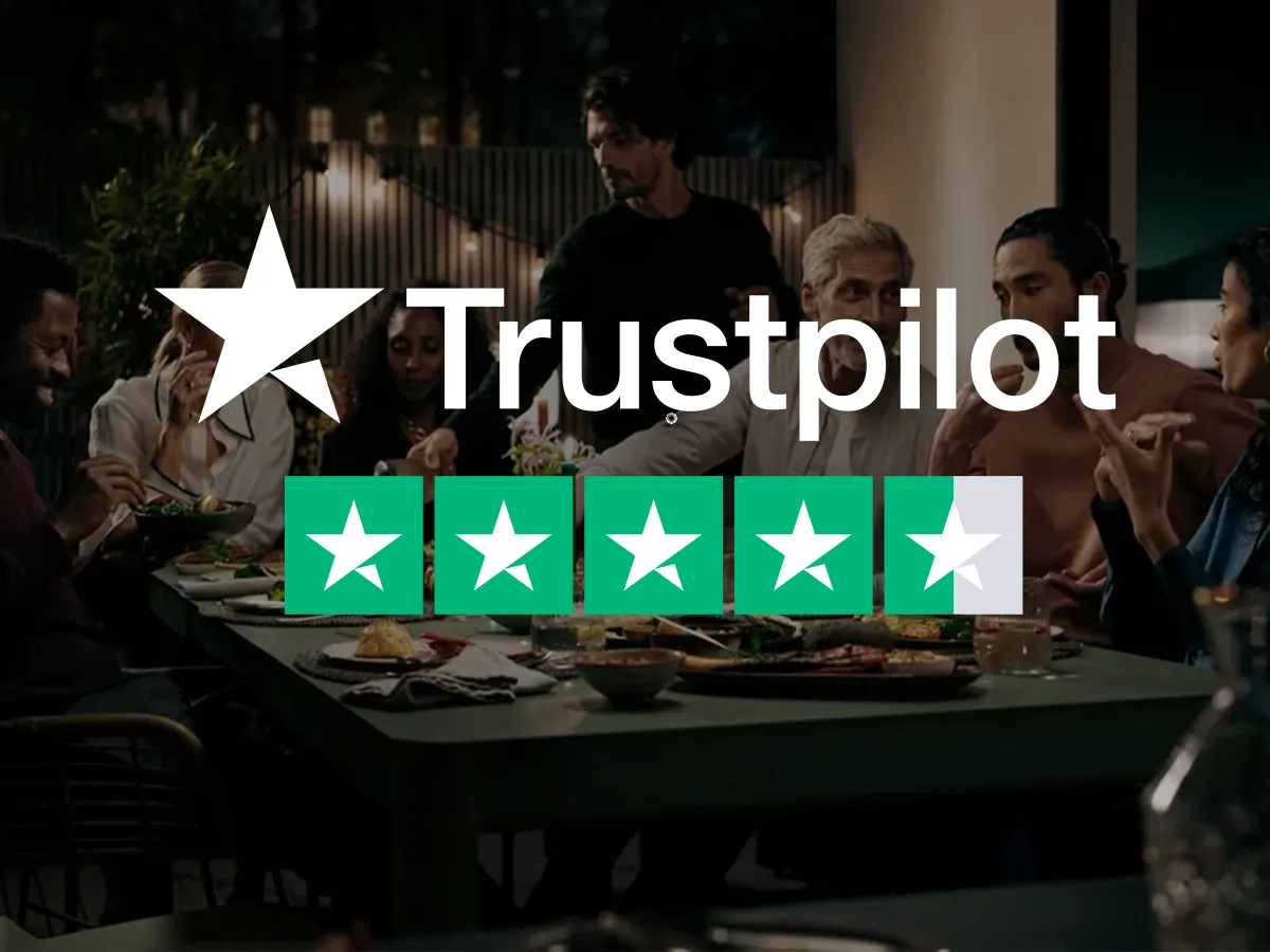 The Trustpilot logo and a 4.5-star rating are superimposed over a scene of a group of friends enjoying an evening dinner party outdoors.