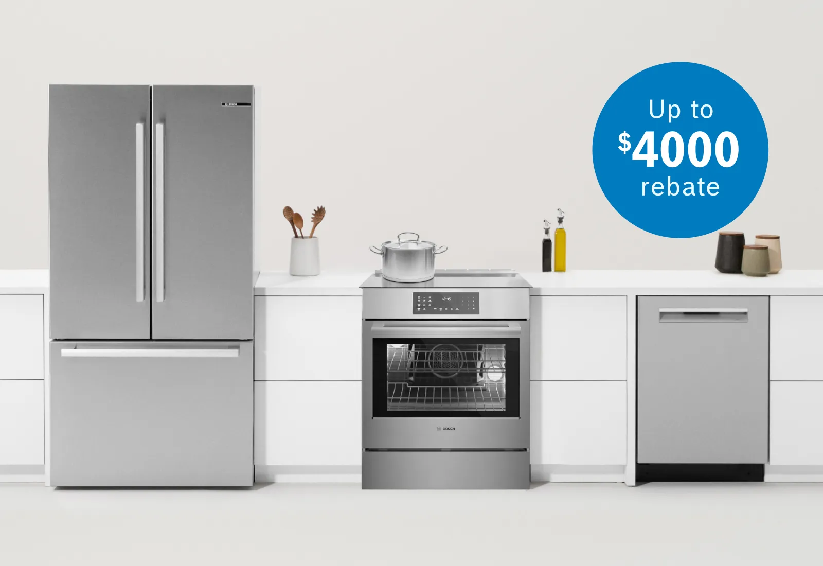 Modern stainless steel kitchen appliances including refrigerator, oven with pot, and dishwasher, with a $4000 rebate offer.