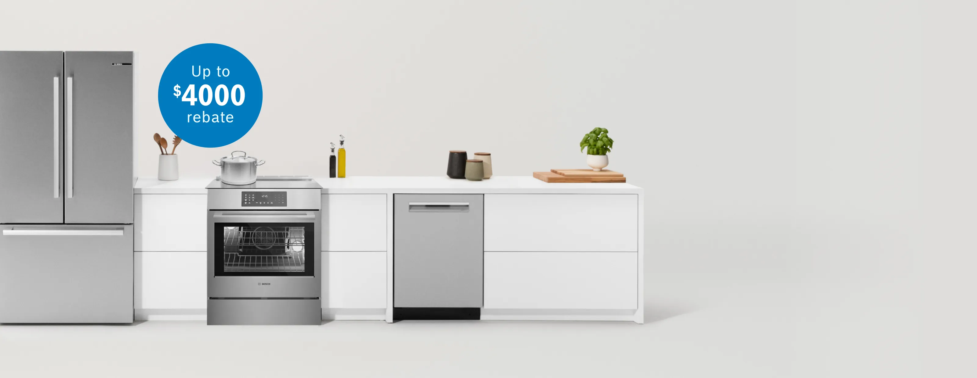 Modern kitchen setup with stainless steel refrigerator, oven, and dishwasher, plus a $4000 rebate promotion in a blue circle.