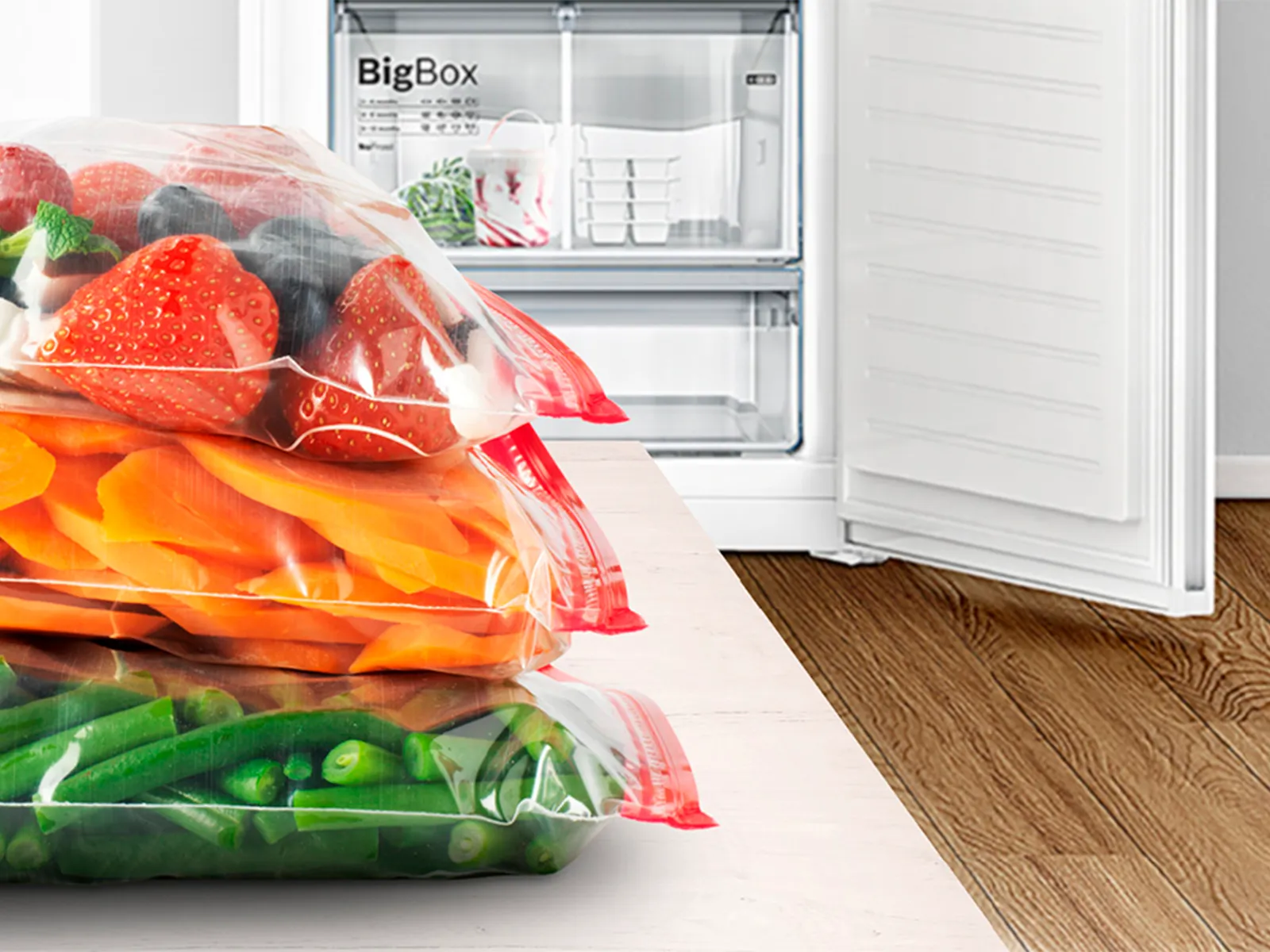Vegetables and fruit in freezer bags. An open freezer in the background.