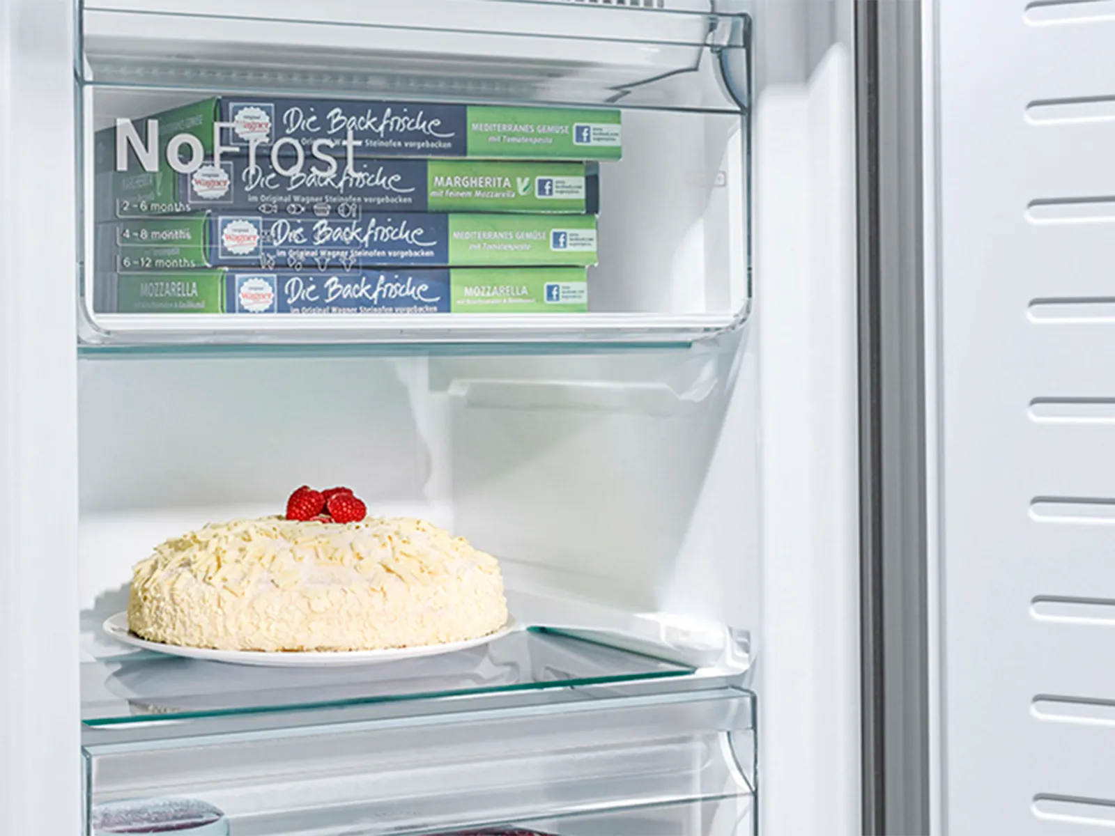 Closeup of freezer interior with drawers and a large shelf to store different items.