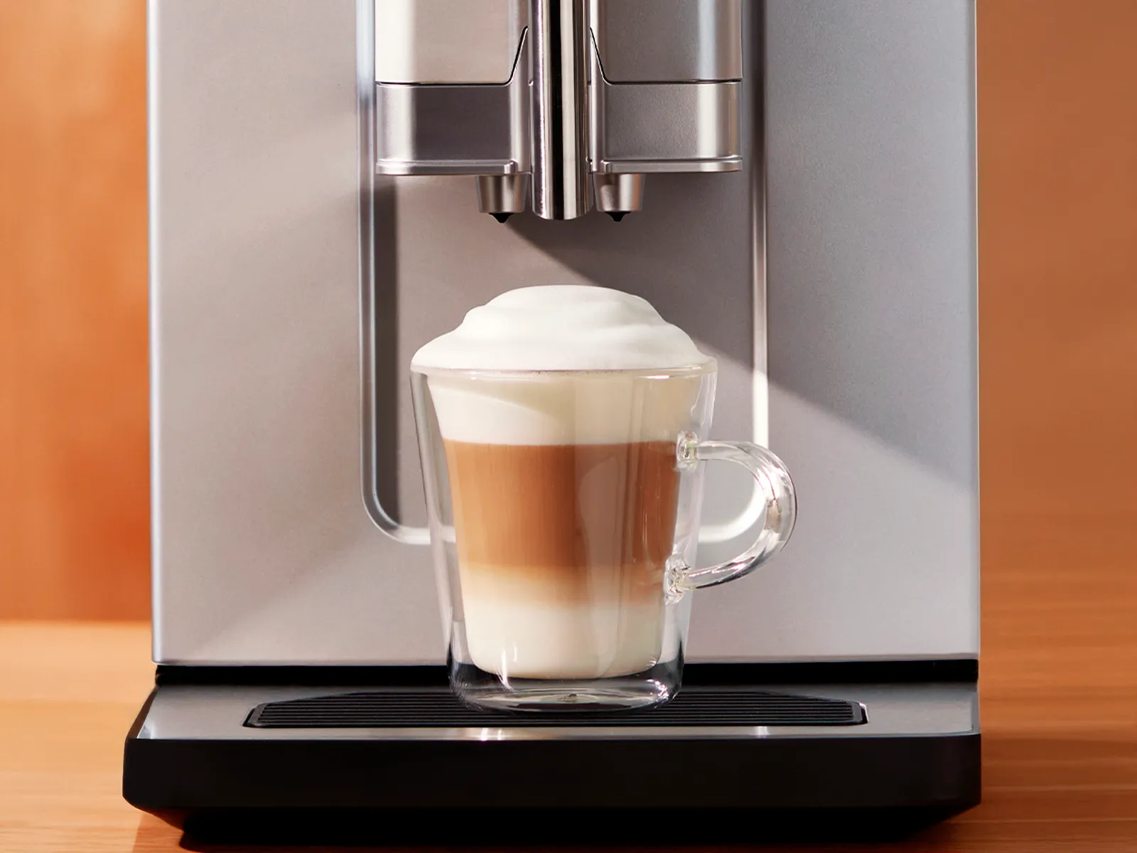 1 cup filled with Cappuccino placed on Series 2 VeroCafe machine drip tray.