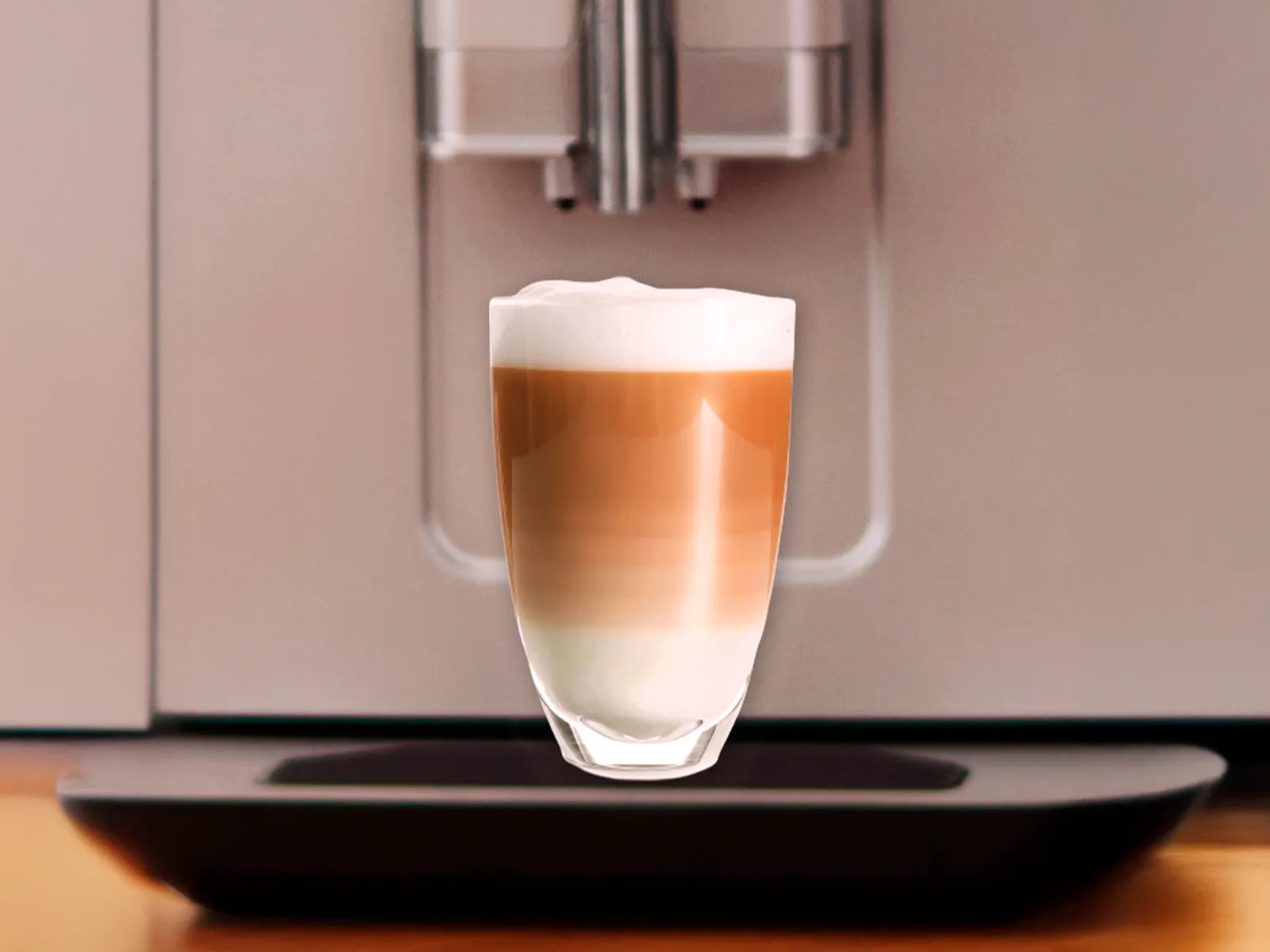 1 cup filled with Latte Macchiato placed on Series 2 VeroCafe machine drip tray.