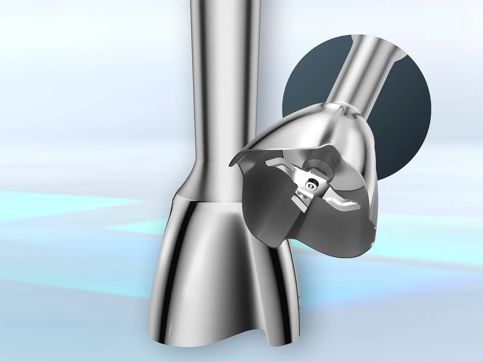 Osnova jednog inox štapnog miksera leži na površini, dok su oštrice vidljive unutar drugog.