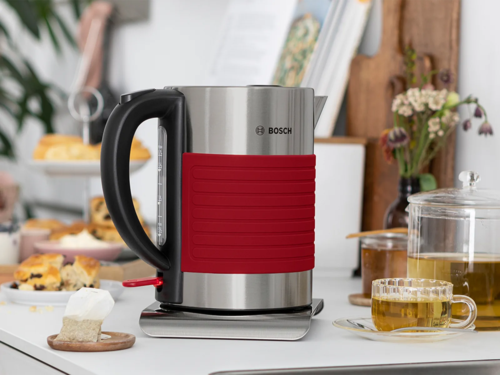 Silicone kettle on a kitchen top in red.