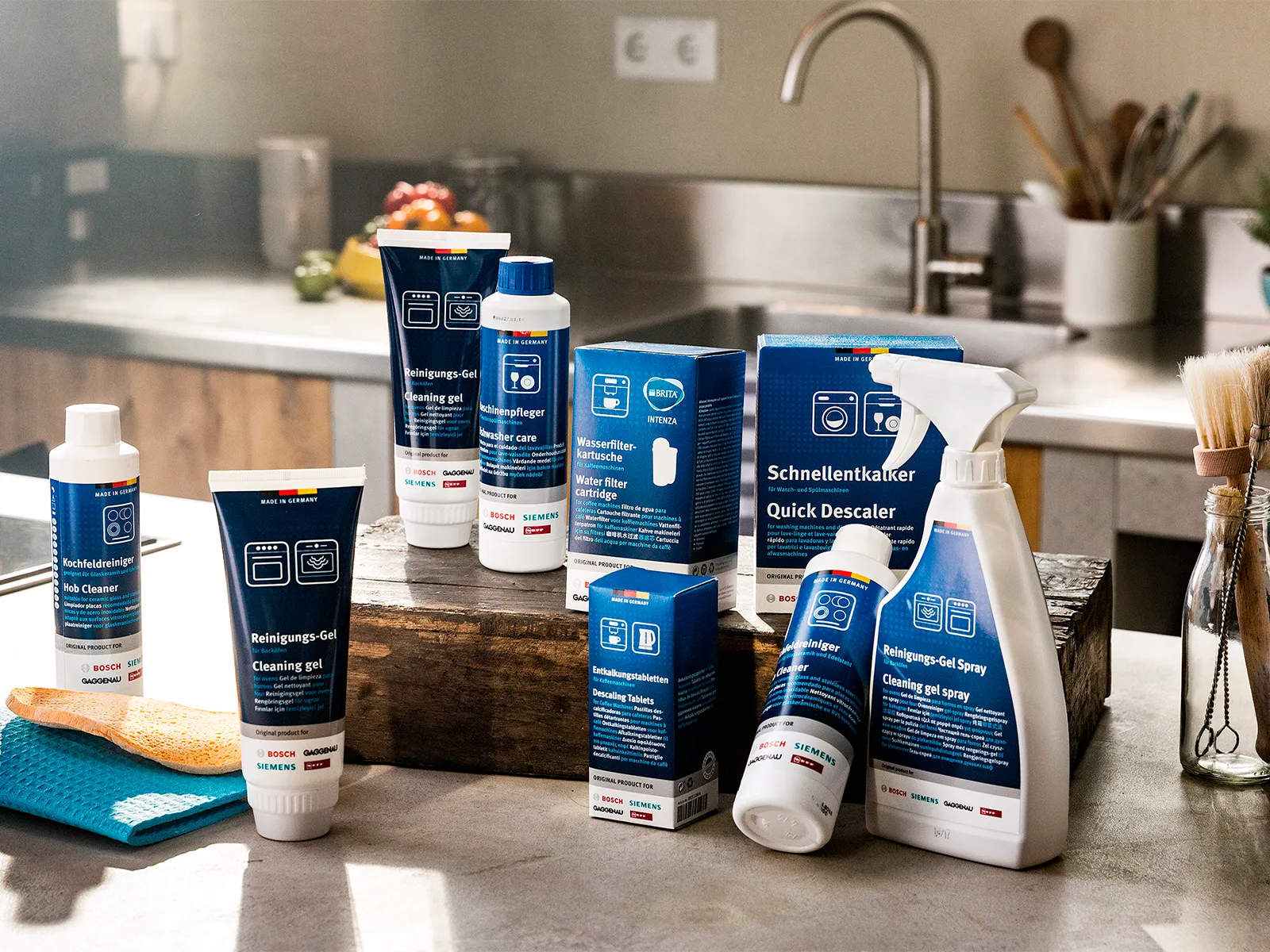 A selection of cleaners and maintenance products displayed on a kitchen countertop