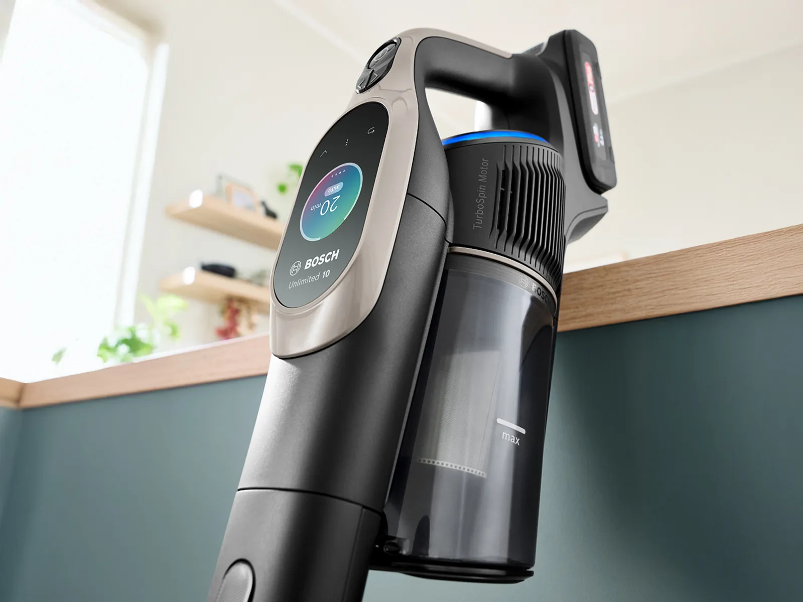 Bosch cordless vacuum cleaner with digital display, resting on a wooden surface.