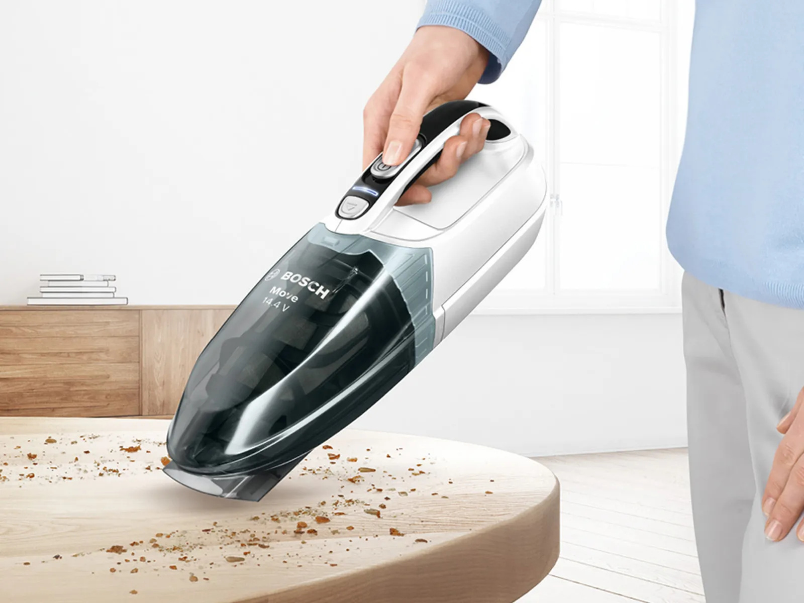Three different types of vacuum cleaners displayed in a bright room.