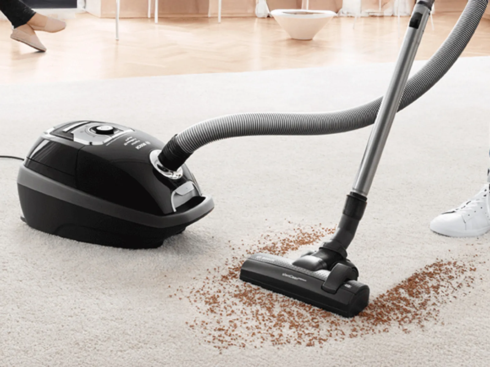 The head of Bosch bagged vacuum cleanly picks up heavy debris off a cream carpet.