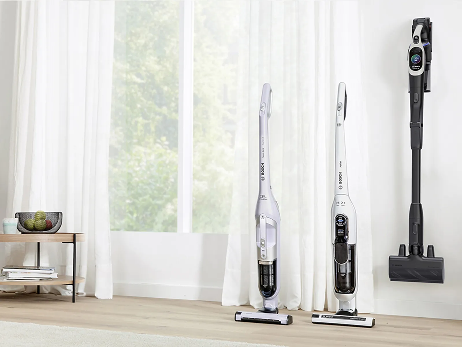 A selection of cordless vacuum cleaners in a living room.