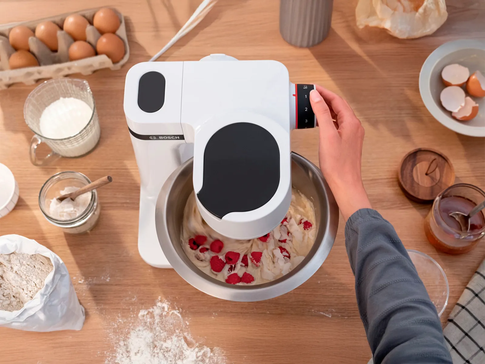 A Series 4 MUM 5 from overhead while it mixes raspberries into cake batter.