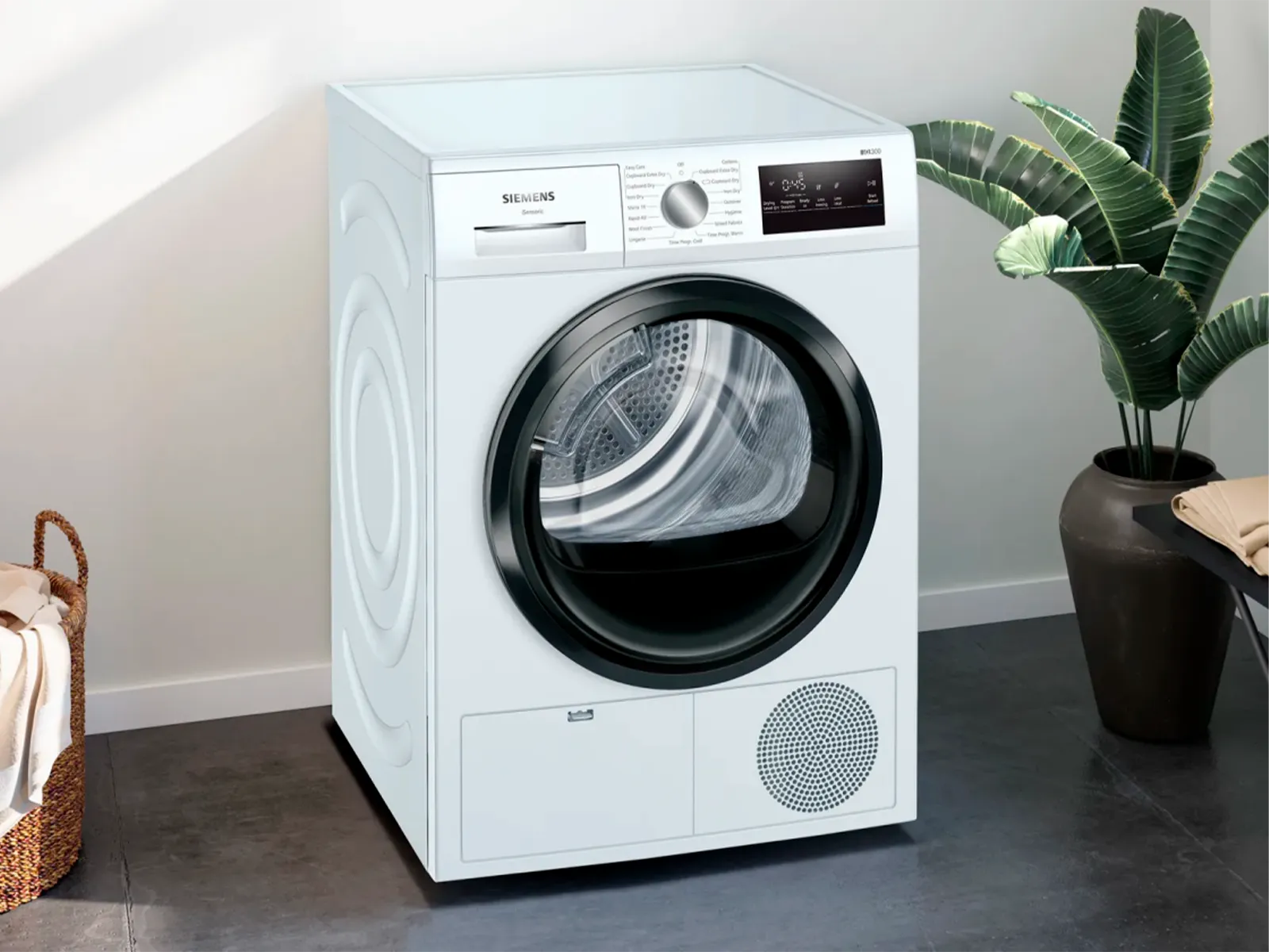 Máquina de lavar frontal moderna numa sala limpa com uma decoração de planta.