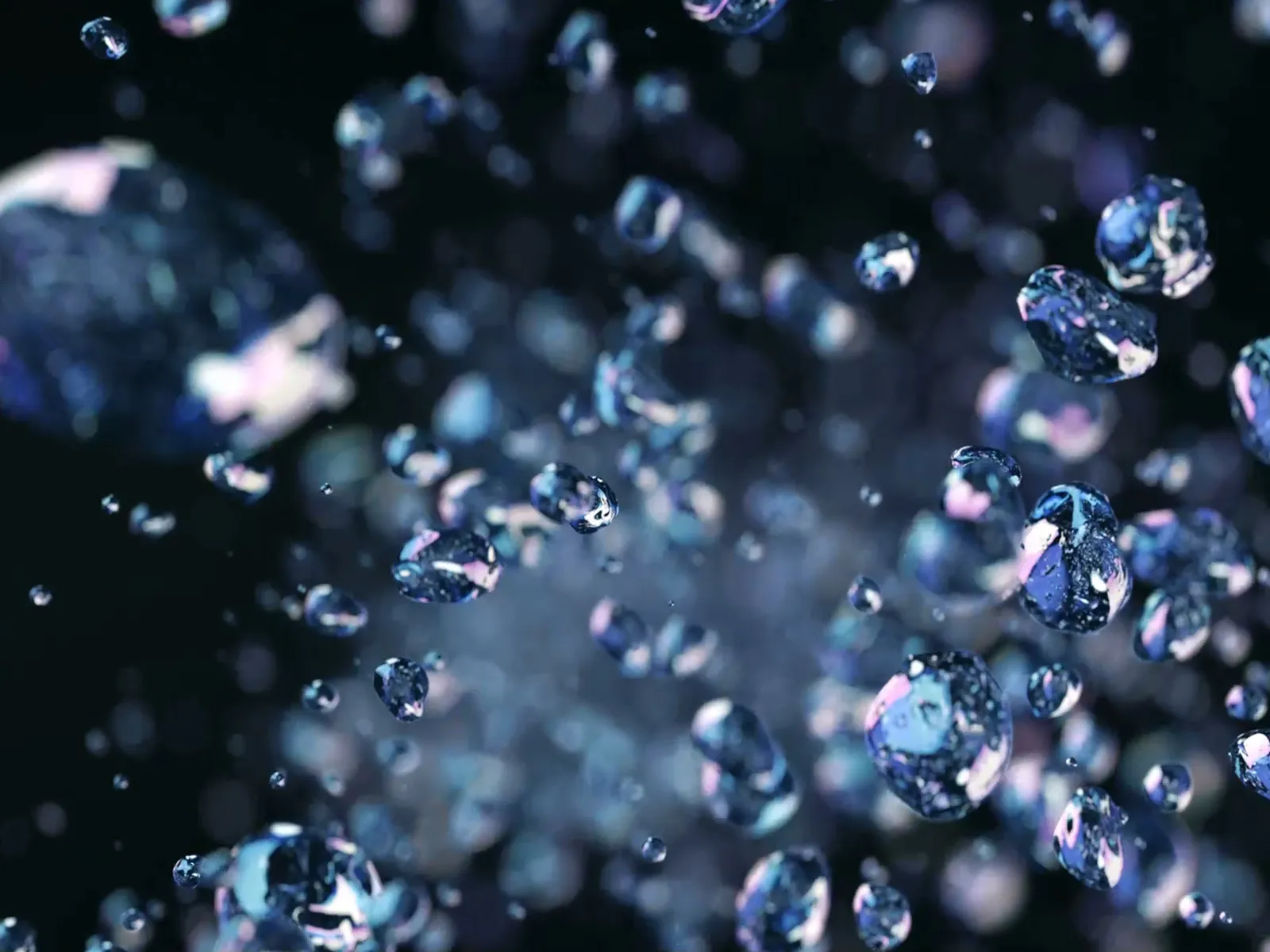 Skinnede blå vanddråber med en mørk baggrund.