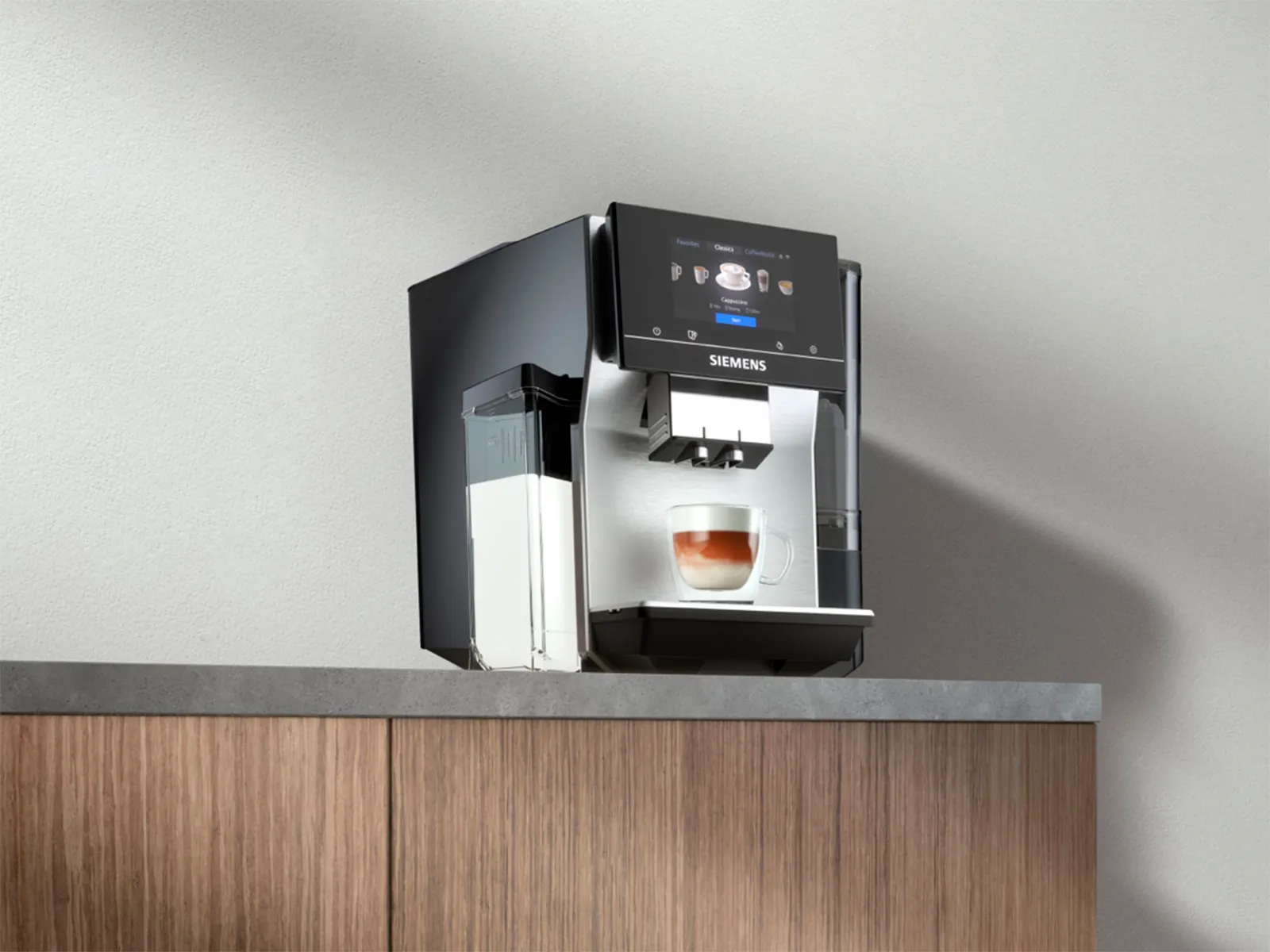 A Siemens espresso machine brewing coffee, placed on a kitchen counter.