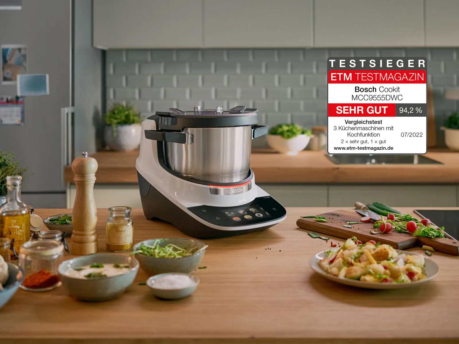 Cookit Cook Processor is placed in the kitchen with food in front.