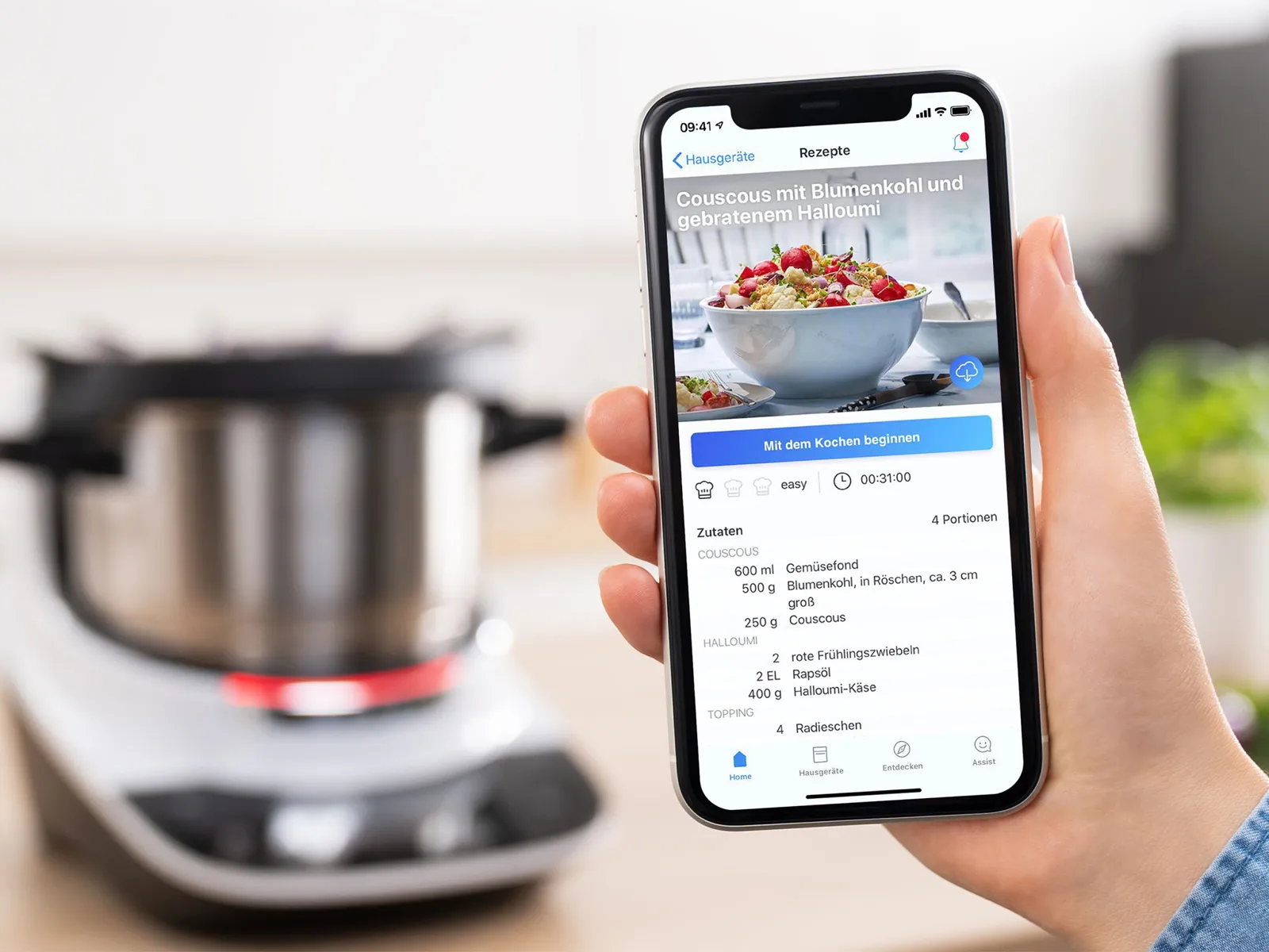 The Home Connect App opened on a smartphone with the Cookit in the back. 