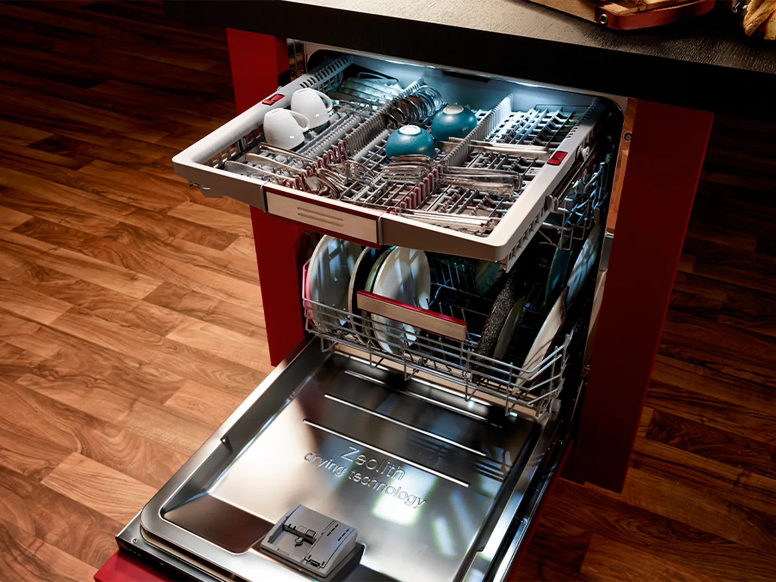 A free-standing, open dishwasher with a cutlery drawer pulled out at the top