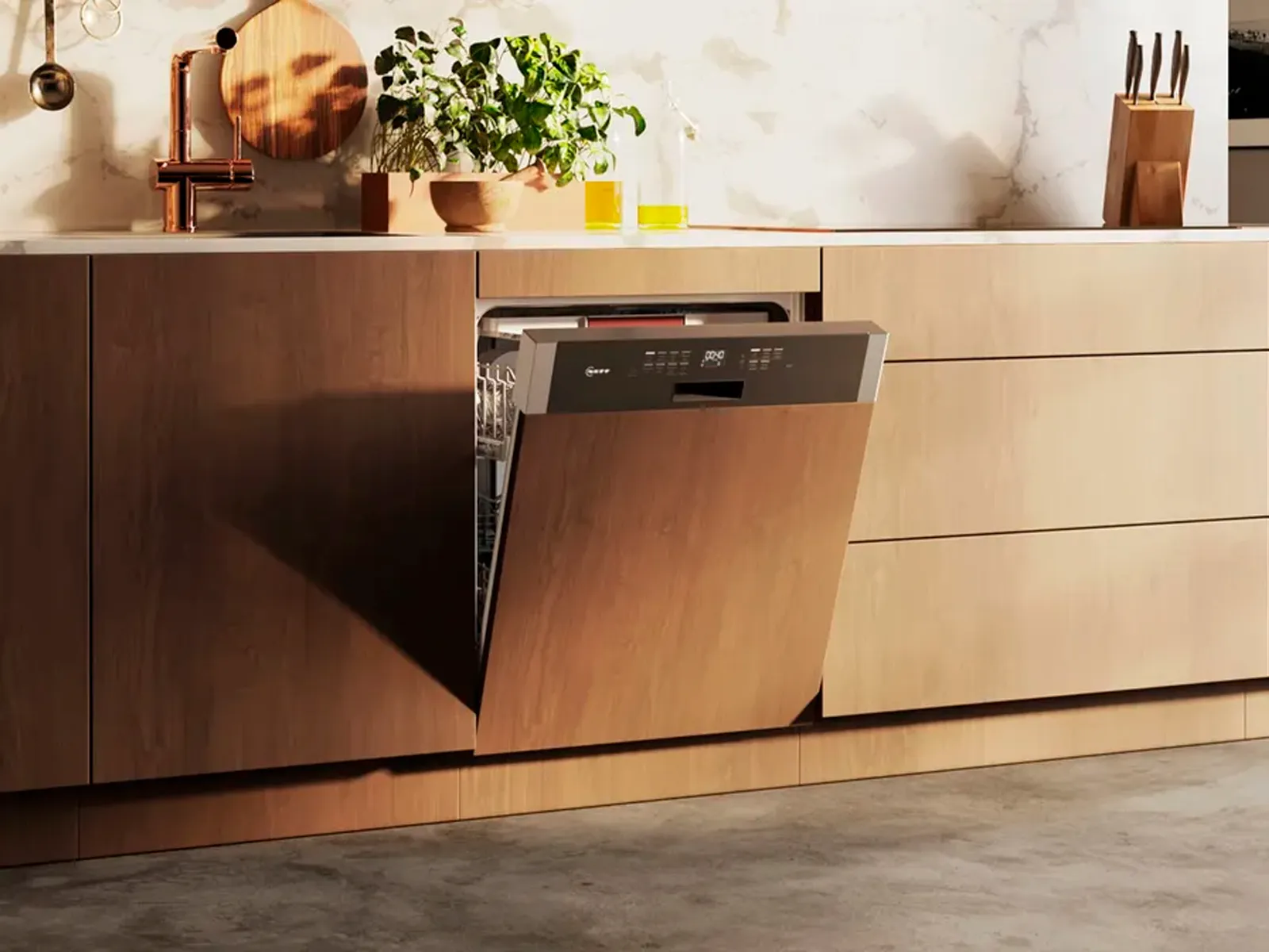 A light-wood kitchen unit with a slightly open semi-integrated dishwasher with a visible control panel