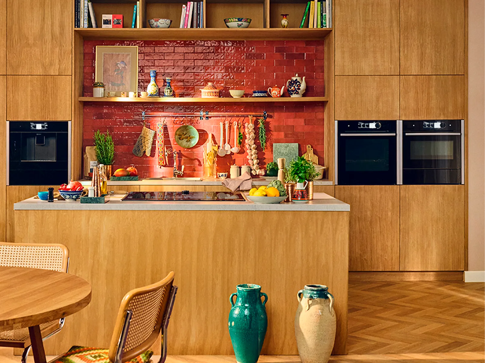 Wide shot of warm wooden kitchen with red tiles 